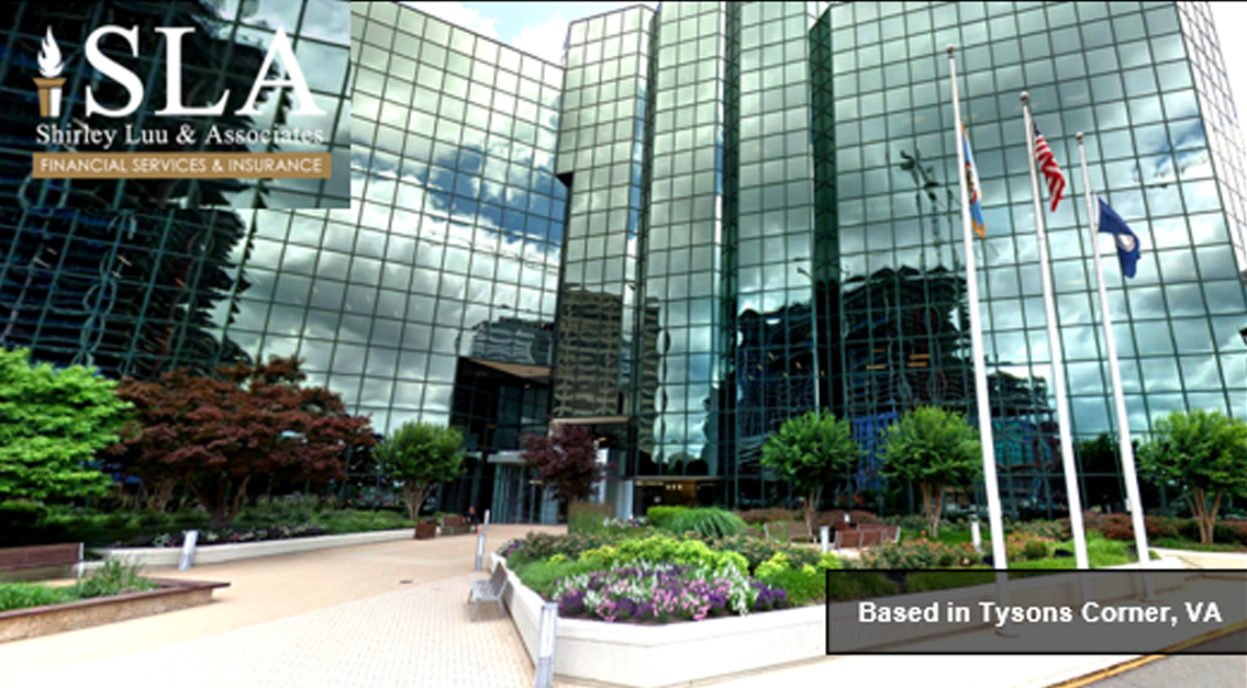 A building with many windows and plants in front of it.